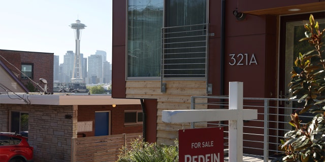 A "For Sale" sign is posted outside a residential home in the Queen Anne neighborhood near the Space Needle in Seattle, Washington, U.S. May 14, 2021. REUTERS/Karen Ducey