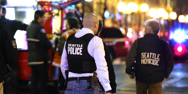 Police look over the scene of a shooting at 3rd Avenue and Pine Streeton January 22, 2020 in the central business district of Seattle, Washington. Police say a woman was killed and seven people hurt, including a 9-year-old boy, by "multiple" shooters, but wouldn't elaborate. (Photo by Karen Ducey/Getty Images)