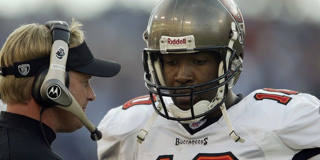 Quarterback Shaun King (10) of the Tampa Bay Buccaneers talks to head coach Jon Gruden during the game against the Tennessee Titans on Dec. 28, 2003, at The Coliseum in Nashville, Tennessee. 