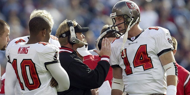 Quarterback Brad Johnson (14) of the Tampa Bay Buccaneers talks to his head coach Jon Gruden during the game against the Tennessee Titans on December 28, 2003 at The Coliseum in Nashville, Tennessee.  The Titans defeated the Buccaneers 33-13.  Quarterback Shaun King (10) is on the left.