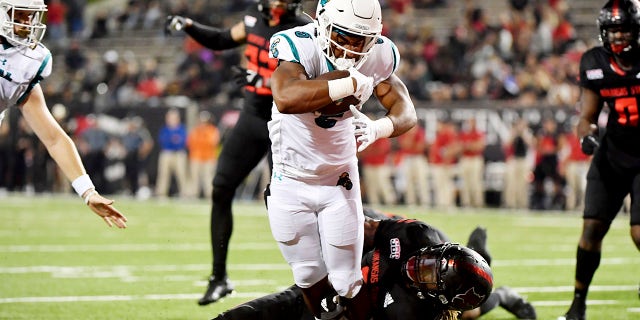 Coastal Carolina running back Shermari Jones (5) runs past Arkansas State defender David Clayton (5) to score a touchdown during the first half of an NCAA college football game Thursday, Okt.. 7, 2021, in Jonesboro, Ark.