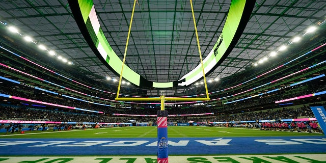 The field at SoFi Stadium sits empty during a weather delay shortly before the scheduled start of an NFL football game between the Los Angeles Chargers and the Las Vegas Raiders, Monday, Oct. 4, 2021, in Inglewood, Calif.