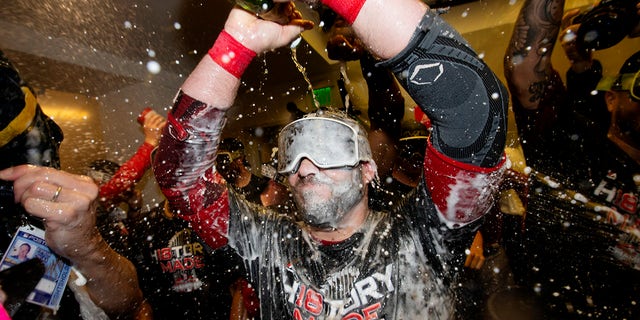 Steve Pearce #25 of the Boston Red Sox is doused with champagne in the clubhouse after the Red Sox defeated the Los Angeles Dodgers in Game 5 of the 2018 World Series at Dodger Stadium on Sunday, Oct. 28, 2018, in Los Angeles, California.