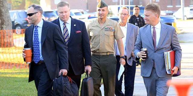 Oct 14, 2021; Jacksonville, NC, USA; Lt. Col. Stuart Scheller Jr. and his lawyers walk to the courtroom on Camp Lejeune in Jacksonville NC on Thursday, Oct. 14, 2021.