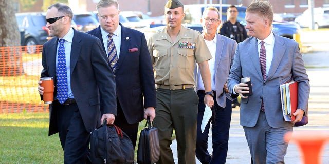 Oct 14, 2021; Jacksonville, NC, USA; Lt. Col. Stuart Scheller Jr. and his lawyers walk to the courtroom on Camp Lejeune in Jacksonville NC on Thursday, Oct. 14, 2021.