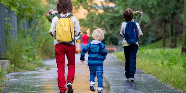 Happy school children going to school 