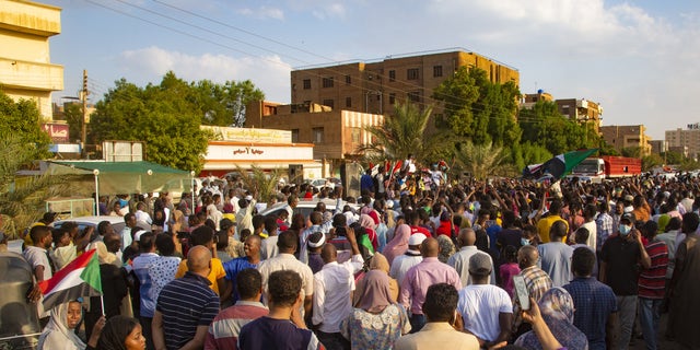 Demonstrators shout slogans as they gather to support current civilian government during a demonstration in Khartoum, Sudan on Oct. 21, 2021. (Photo by Mahmoud Hjaj/Anadolu Agency via Getty Images)