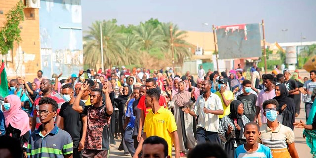 Thousands of pro-democracy protesters take to the streets to condemn a takeover by military officials in Khartoum, Sudan, Monday Oct. 25, 2021. Sudan’s military seized power Monday, dissolving the transitional government hours after troops arrested the acting prime minister and other officials. (AP Photo/Ashraf Idris)