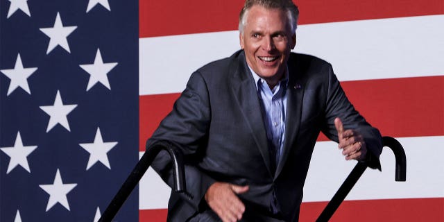 Democratic candidate for governor of Virginia Terry McAuliffe walks up to the stage at a rally in Arlington, Virginia, on Oct. 26, 2021.