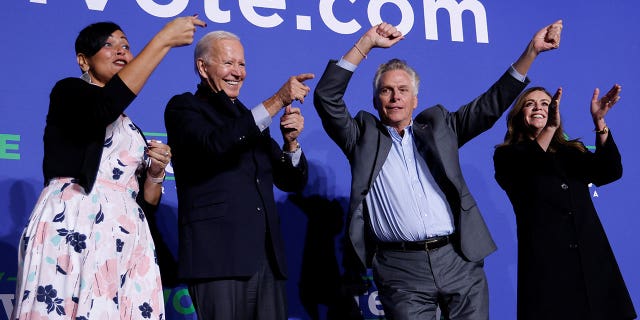 Democratic candidate for governor of Virginia Terry McAuliffe dances onstage next to his wife Dorothy, U.S. President Joe Biden, and Democratic Virginia Lt. Gov. candidate Hala Ayala at a rally in Arlington, Virginia, U.S. October 26, 2021.