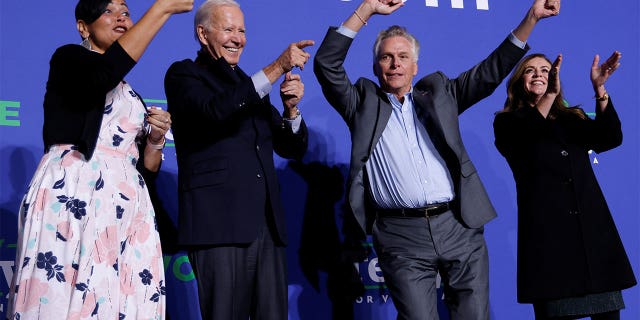 Democratic candidate for governor of Virginia Terry McAuliffe dances onstage next to his wife Dorothy, U.S. President Joe Biden, and Democratic Virginia Lt. Gov. candidate Hala Ayala at a rally in Arlington, Virginia, U.S. October 26, 2021. REUTERS/Jonathan Ernst