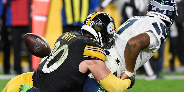 Seattle Seahawks quarterback Geno Smith (7) fumbles as Pittsburgh Steelers outside linebacker T.J. Watt (90) tackles him during overtime Sunday, Oct. 17, 2021, in Pittsburgh.