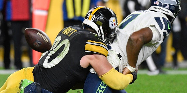Seattle Seahawks quarterback Geno Smith (7) fumbles as Pittsburgh Steelers outside linebacker T.J. Watt (90) tackles him during overtime Sunday, Ott. 17, 2021, a Pittsburgh.