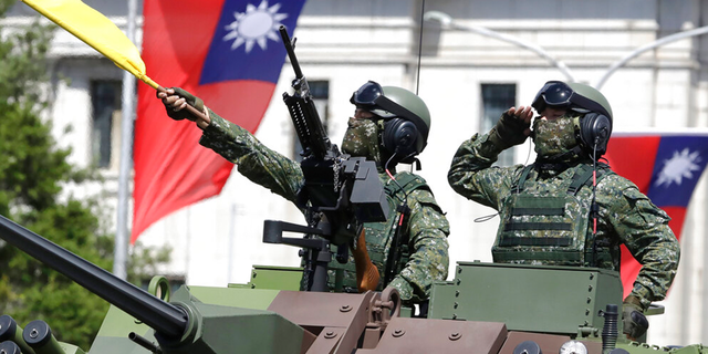 FILE: Taiwanese soldiers salute during National Day celebrations in front of the Presidential Building in Taipei, Taiwan. 