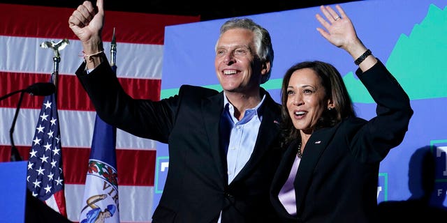 Vice President Kamala Harris waves to the crowd along with Democratic gubernatorial candidate, former Virginia Gov. Terry McAuliffe, left, during a rally in Dumfries, Va., Thursday, Oct. 21, 2021. McAuliffe will face Republican Glenn Youngkin in the November election. 