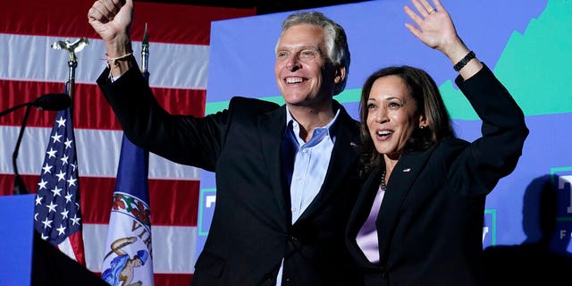 Vice President Kamala Harris waves to the crowd along with Democratic gubernatorial candidate, former Virginia Gov. Terry McAuliffe, left, during a rally in Dumfries, Va., Thursday, Oct. 21, 2021. McAuliffe will face Republican Glenn Youngkin in the November election. (AP Photo/Steve Helber)