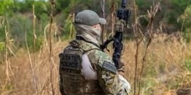 An armed law enforcement officer stands in Starr County, Texas near the U.S.-Mexico border. Texas National Guard soldiers were fired upon by suspected cartel gunmen on Thursday, authorities said.