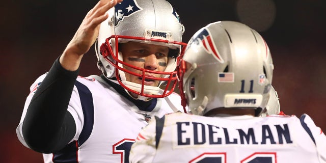 New England Patriots quarterback Tom Brady (12) celebrates a touchdown with wide receiver Julian Edelman (11) during the first half of the AFC Championship game Kansas City Chiefs at Arrowhead Stadium.