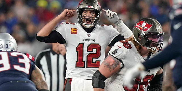 Tampa Bay Buccaneers quarterback Tom Brady (12) calls out a play at the line of scrimmage during the second half of an NFL football game against the New England Patriots, Sunday, Oct. 3, 2021, in Foxborough, Mass.