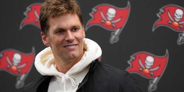 Tampa Bay Buccaneers quarterback Tom Brady smiles while talking with reporters after defeating the New England Patriots 19-17 in an NFL football game, Monday, Oct. 4, 2021, in Foxborough, Mass.