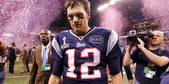 New England Patriots quarterback Tom Brady leaves the field after their loss to the New York Giants in the NFL Super Bowl XLVI football game in Indianapolis, Indiana.