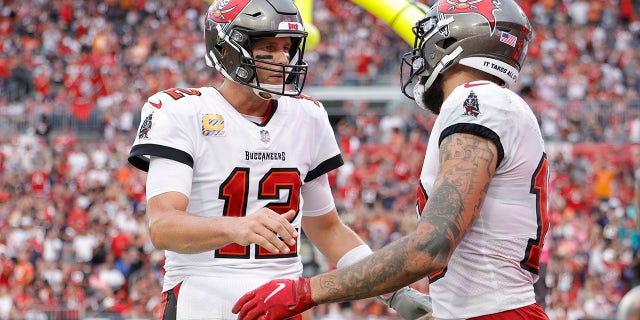 TAMPA, FLORIDA - OCTOBER 24: Tom Brady #12 and Mike Evans #13 of the Tampa Bay Buccaneers celebrate after scoring a touchdown in the second quarter against the Chicago Bears in the game at Raymond James Stadium on October 24, 2021 in Tampa, Florida.