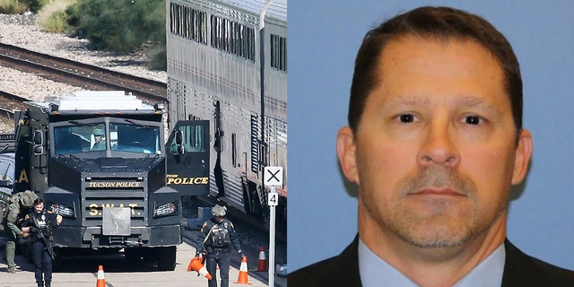 A Tucson Police Department SWAT truck is parked near the last two cars of an Amtrak train in Tucson, Ariz. On Monday after a shooting left DEA officer Michael "Mike" Garbo dead (Associated Press, DEA)