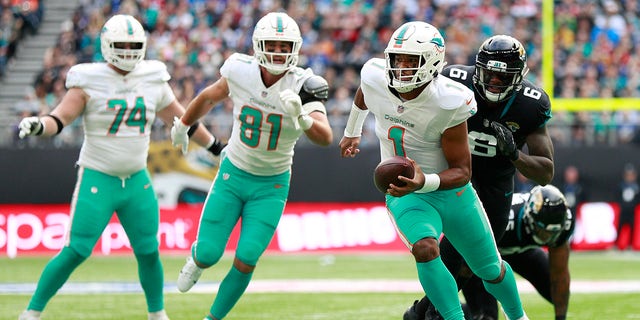 Miami Dolphins quarterback Tua Tagovailoa (1) runs with the ball during an NFL football game between the Miami Dolphins and the Jacksonville Jaguars at the Tottenham Hotspur stadium in London, England, Sunday, Oct. 17, 2021.
