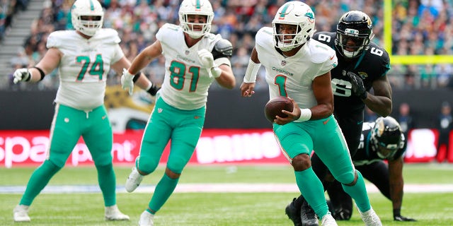 Miami Dolphins quarterback Tua Tagovailoa (1) runs with the ball during an NFL football game between the Miami Dolphins and the Jacksonville Jaguars at the Tottenham Hotspur stadium in London, England, Sunday, Oct. 17, 2021.