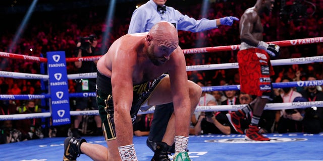 Tyson Fury, of England, stands up after being knocked down by Deontay Wilder in a heavyweight championship boxing match on Saturday, October 9, 2021, in Las Vegas. 