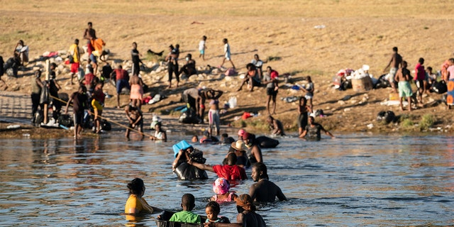 Migrants crossing the Rio Grande near the International Bridge between Mexico and the U.S. on Sept. 22.