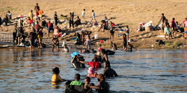 Migrants crossing the Rio Grande near the International Bridge between Mexico and the U.S. on Sept. 22.