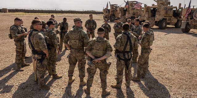 U.S. Army soldiers prepare to go out on patrol from a remote combat outpost on May 25, 2021 in northeastern Syria.