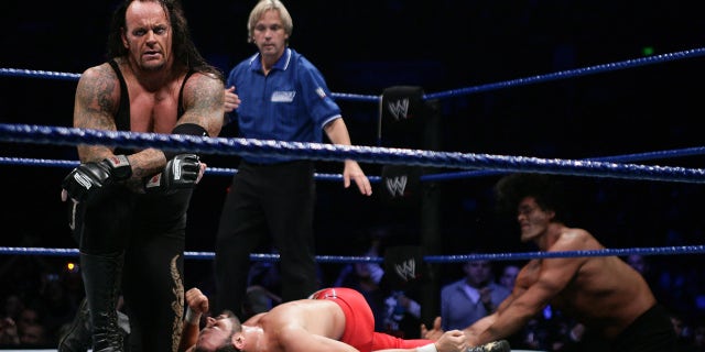 The Undertaker (L) celebrates his victory during the WWE Smackdown at Acer Arena June 15, 2008 in Sydney, Australia.