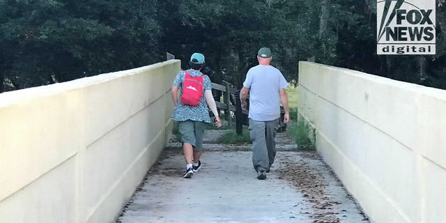 Chris and Roberta Laundrie cross a bridge in the Myakkahatchee Creek Environmental Park Wednesday