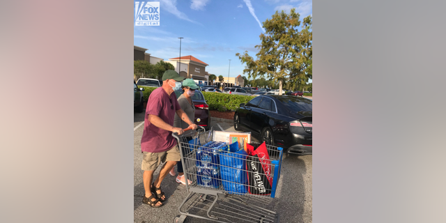 Chris and Roberta Laundrie push a shopping cart on Oct. 19, 2021, the day before their son's remains were found in the area they had been telling investigators to search for weeks.