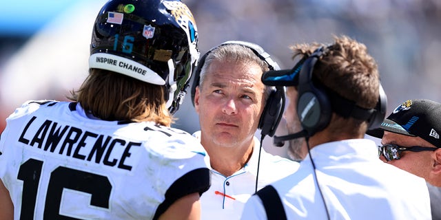 Head coach Urban Meyer of the Jacksonville Jaguars speaks with Trevor Lawrence #16 during the game against the Arizona Cardinals at TIAA Bank Field on September 26, 2021 in Jacksonville, Florida.