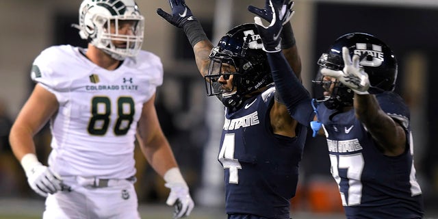 Utah State's Shaq Bond (4) and Hunter Reynolds celebrate after Colorado State missed a potential game-winning field goal, next to Colorado State's Brian Polendey (88) during the second half of an NCAA college football game Friday, Oct. 22, 2021, in Logan, Utah.