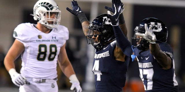 Utah State's Shaq Bond (4) and Hunter Reynolds celebrate after Colorado State missed a potential game-winning field goal, next to Colorado State's Brian Polendey (88) during the second half of an NCAA college football game Friday, Oct. 22, 2021, in Logan, Utah.