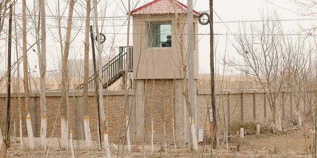 A security person watches from a watchtower around a detention facility in Yarkent County, Xinjiang Uyghur Autonomous Region, northwest China.