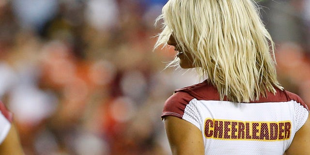 A Washington cheerleader dances on the field during a timeout against the Cincinnati Bengals at FedExField.