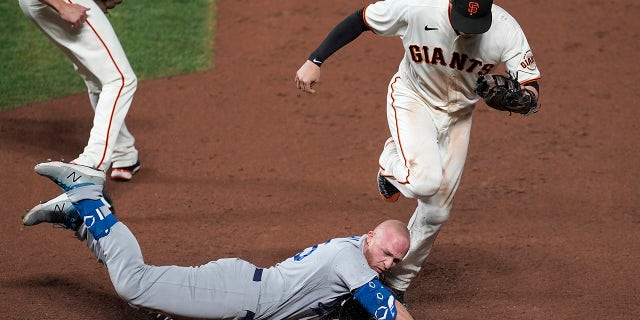 San Francisco Giants first baseman Wilmer Flores, top, forces Los Angeles Dodgers' Matt Beaty out at first during the ninth inning of Game 5 of a baseball National League Division Series Thursday, Oct. 14, 2021, in San Francisco.