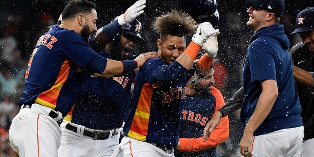 Houston Astros' Yuli Gurriel, center, celebrates his winning hit during the ninth inning of a baseball game against the Oakland Athletics, Sunday, Oct. 3, 2021, in Houston.