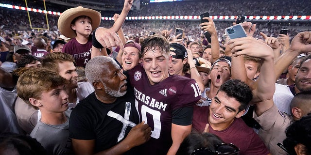 Texas A&M quarterback Zach Calzada (10) is surrounded by fans following the team's victory over Alabama in an NCAA college football game on Saturday October 9, 2021 in College Station, Texas.