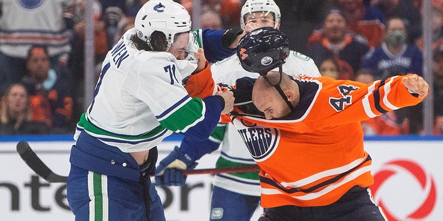 Vancouver Canucks Zack MacEwen (71) and Edmonton Oilers Zack Kassian (44) face off in the third period of an NHL pre-season game on Thursday, October 7, 2021 in Edmonton, Alta.