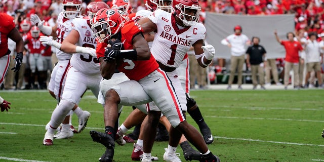Georgia running back Zamir White (3) gets past Arkansas defensive back Jalen Catalon (1) to score a touchdown during the first half of an NCAA college football game Saturday, Oct. 2, 2021, in Athens, Ga..