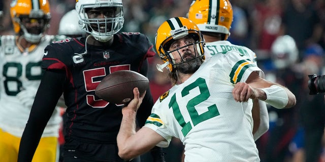 Green Bay Packers quarterback Aaron Rodgers (12) throws the ball into the crowd as time expires during the second half of an NFL football game against the Arizona Cardinals, Thursday, Oct. 28, 2021, in Glendale, Arizona. The Packers won 24-21.