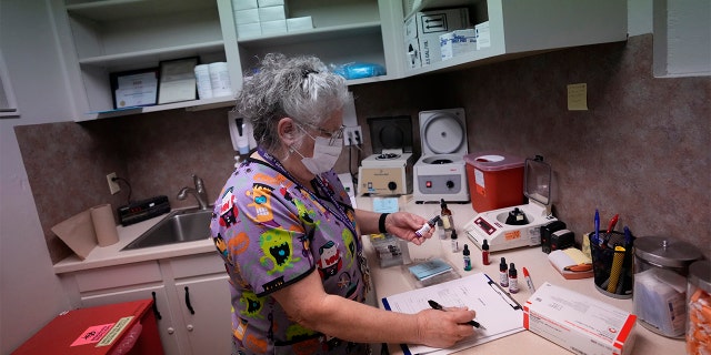 Lab technician Stephannie Chaffee prepares materials that will be used to test women's blood ahead of the arrival of patients, Saturday, Oct. 9, 2021, at Hope Medical Group for Women in Shreveport, La. (AP Photo/Rebecca Blackwell)