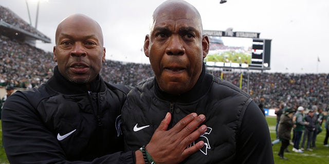 Michigan State coach Mel Tucker, right, is congratulated by athletic director Alan Haller following a 37-33. win over Michigan in an NCAA college football game, Saturday, Oct. 30, 2021, in East Lansing, Mich.