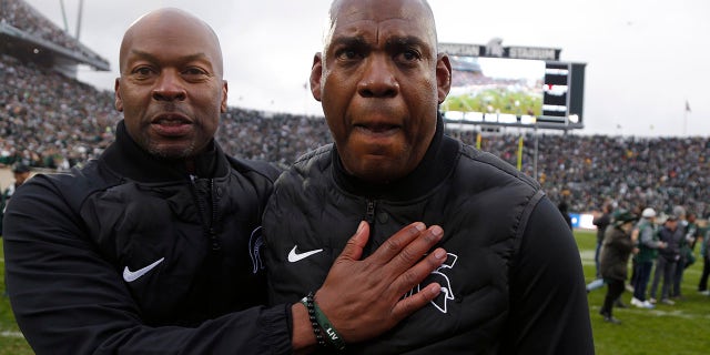 Michigan State coach Mel Tucker, right, is congratulated by athletic director Alan Haller following a 37-33. win over Michigan in an NCAA college football game, Saturday, Oct. 30, 2021, in East Lansing, Mich.